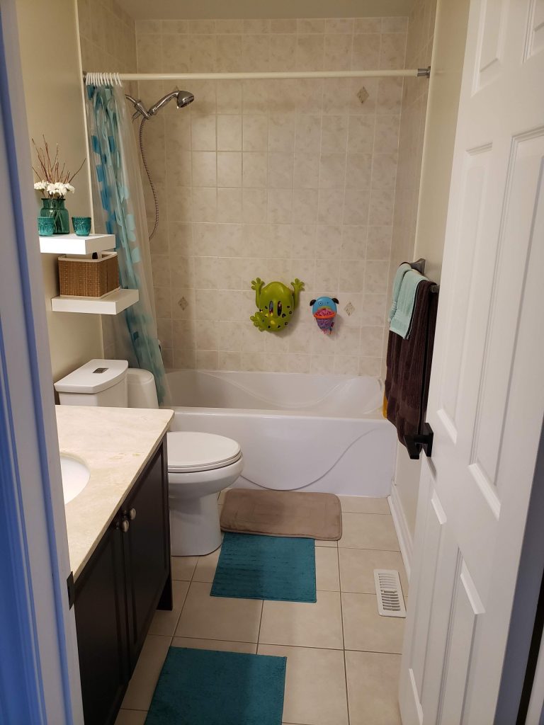 Before picture of a beige outdated bathroom