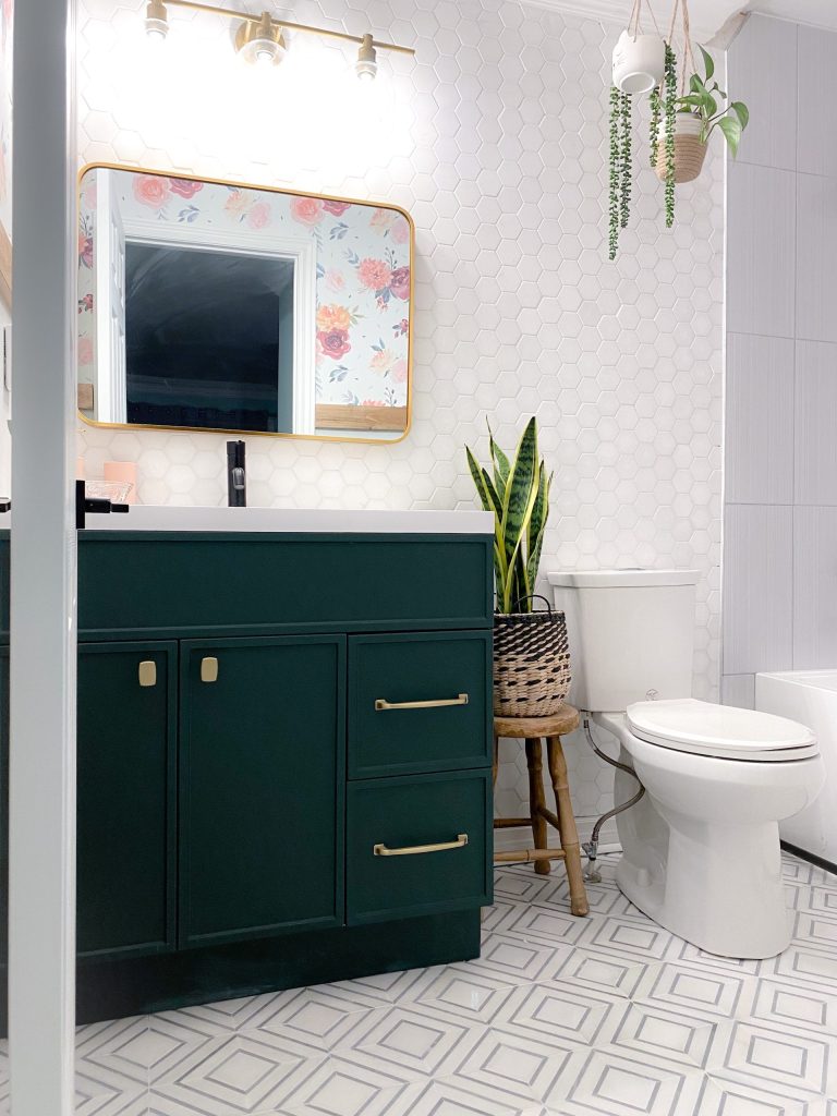 Bathroom with hexagon wall tiles, green vanity and pattern floor tile