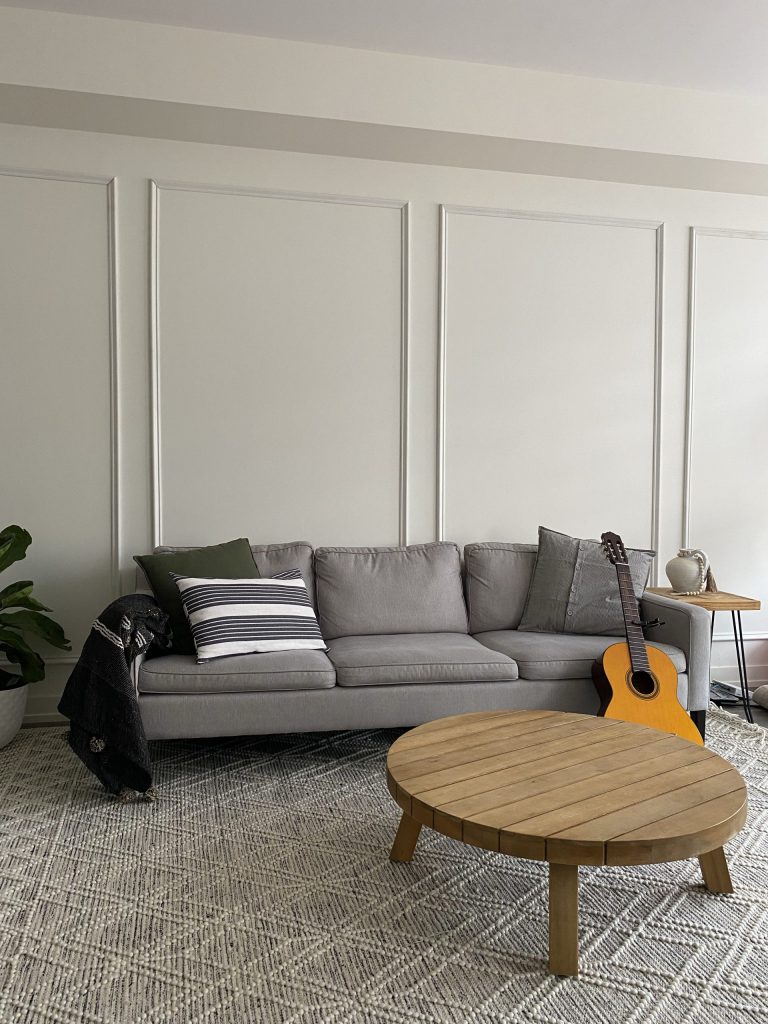 A modern living room accent wall with picture frame molding