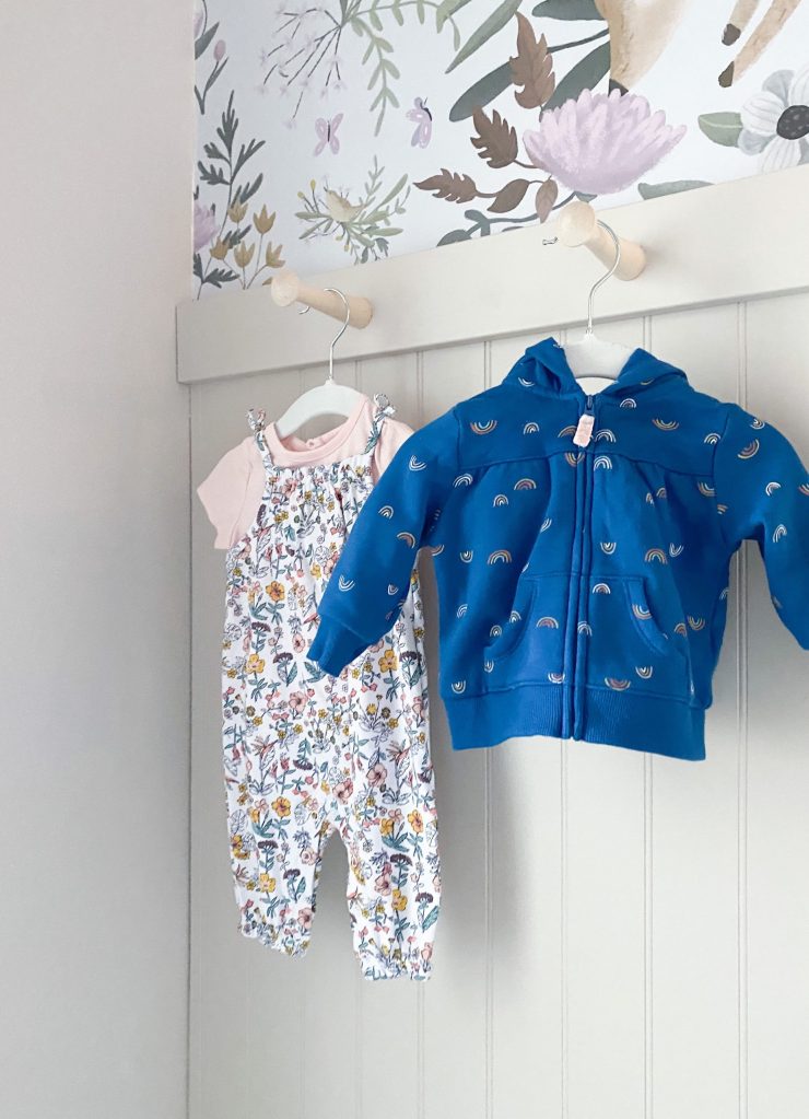 Hanging clothes as decor in a girls nursery