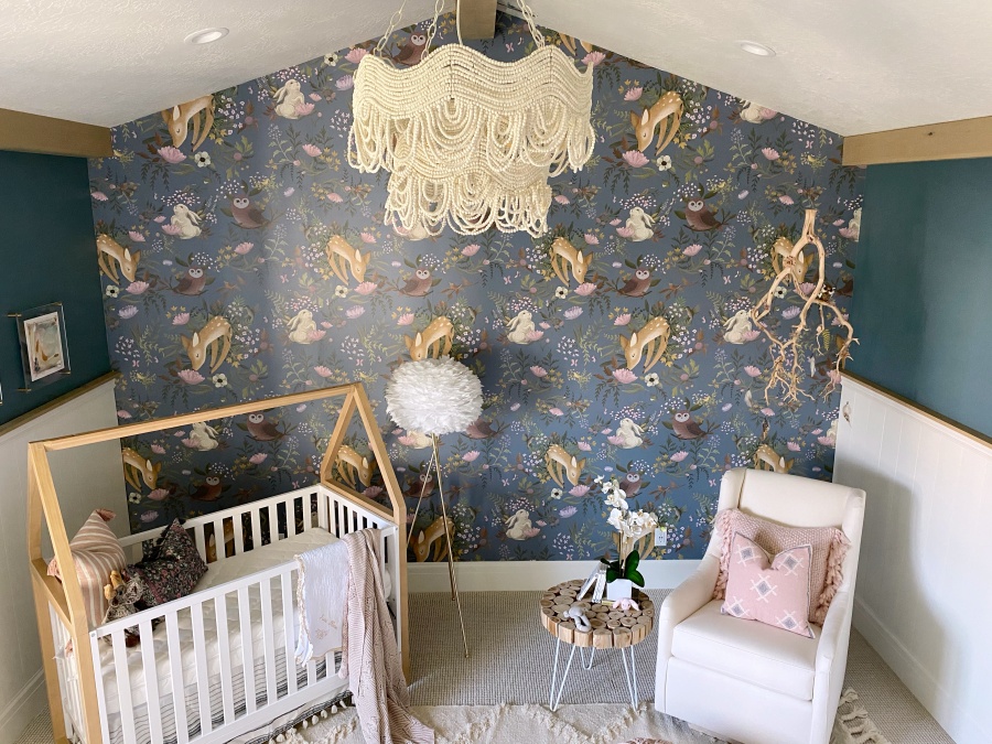 baby girl woodland theme nursery with white crib and white glider