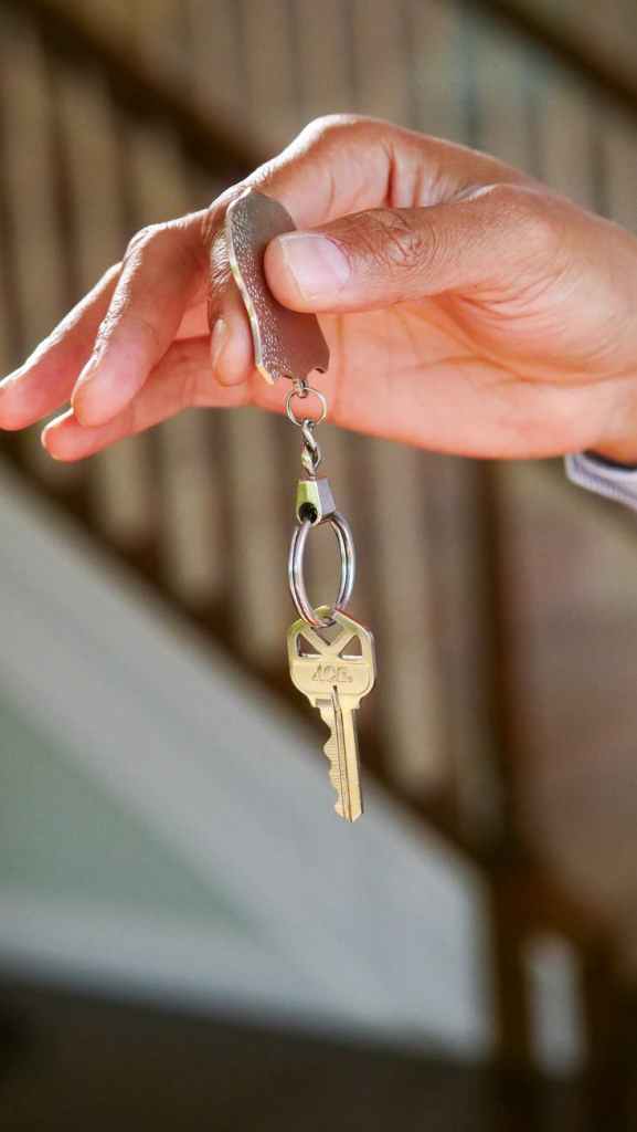 person holding a keychain with key