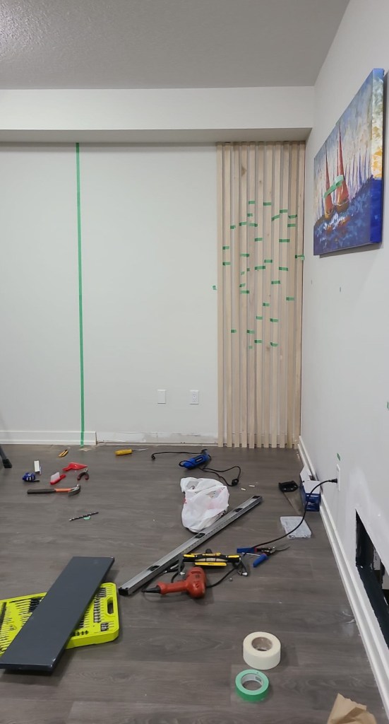 Using painter's tape to stick the slats on the wall and visualize the result. 