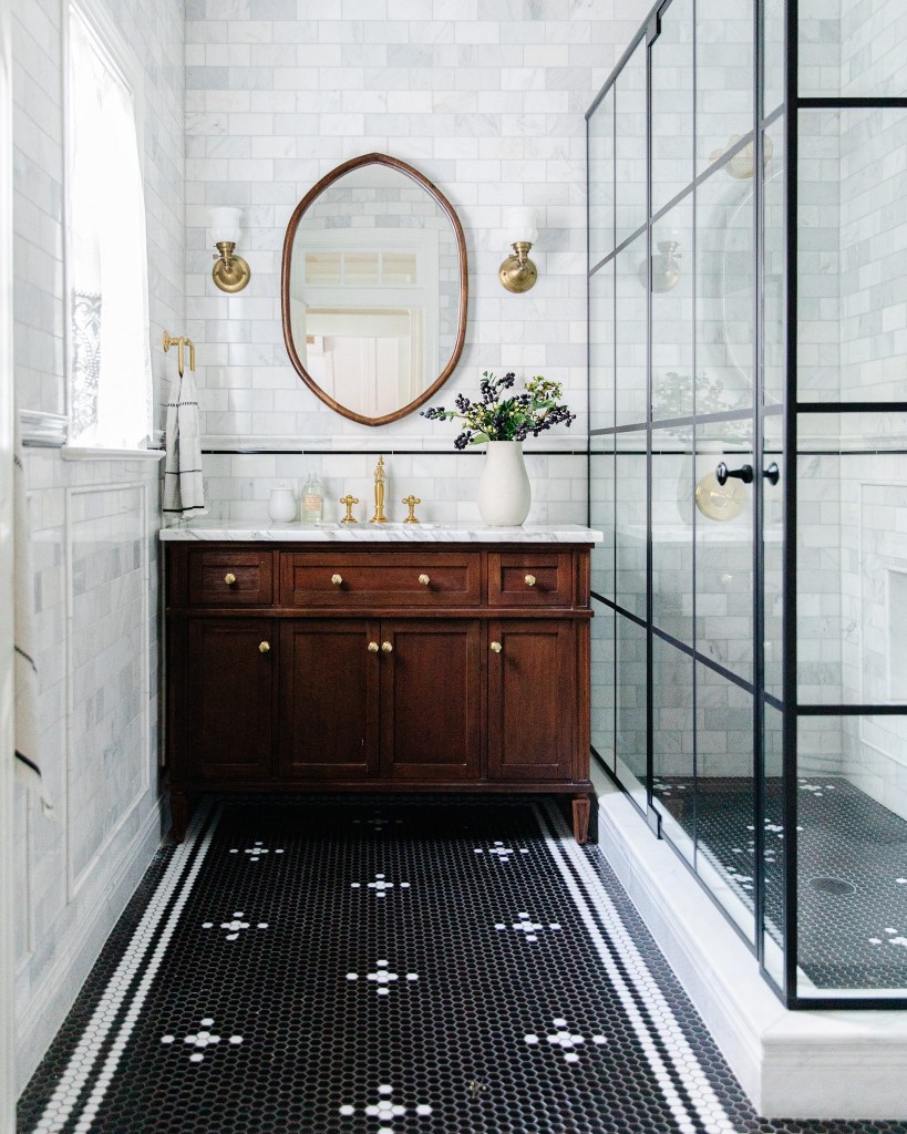 2024 bathroom design inspo with this modern black grid shower and black and white penny tiles. bathroom by chris loves julia.  
